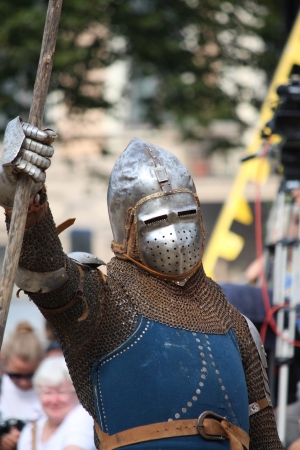 RIGA, LATVIA - AUGUST 21: Unidentified man from historical reconstruction club "Sword and Raven" inmetal  armor and helmet during Riga Festival on August 21, 2011 in Riga, Latvia の写真素材
