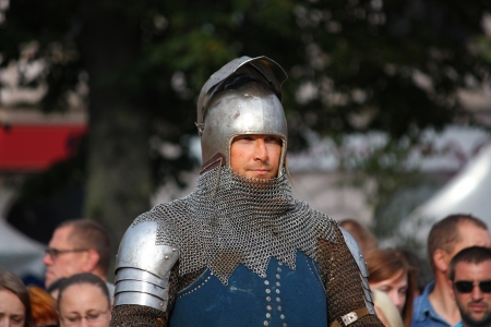 RIGA, LATVIA - AUGUST 21: Unidentified man from historical reconstruction club "Sword and Raven" inmetal  armor and helmet during Riga Festival on August 21, 2011 in Riga, Latvia のeditorial素材