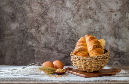 Baked bread with cereals placed on a wooden table.の写真素材