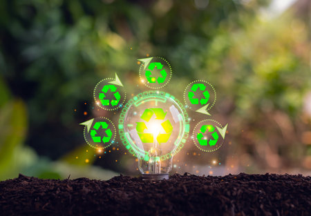 Light bulb placed on the floor surrounded by natural elements, symbolizing energy saving and...