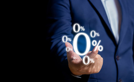 Businessman using mobile with zero percentage or 0 percent for Interest free,with a glowing 0% symbol prominently displayed on the screen, representing interest-free offers or zero-interest financing.の写真素材