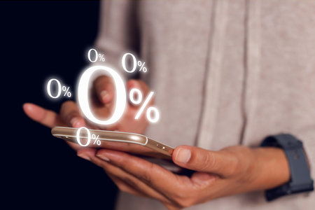business woman using mobile with zero percentage or 0 percent for Interest free,with a glowing 0% symbol prominently displayed on the screen, representing interest-free offers or zero-interest financing.の写真素材