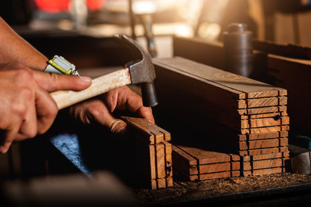 Close-up of a carpenter using a circular saw or a tool to cut wooden planks To make furniture in homes and residences, hotels, rooms made of wood.の写真素材