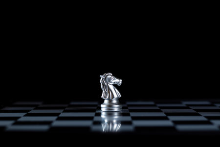 silver Knight stands out  board, rising dark black against the golden pieces successfully convey  unique Queens strategy, thinking out of the box that will become a strategic business thinking idea.の写真素材