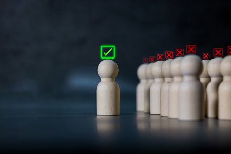 Wooden human figures with glowing check mark and cross icons, representing choice, decision making, evaluation, approval and rejection.の写真素材