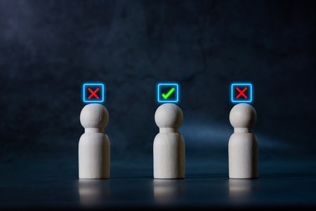 Wooden human figures with glowing check mark and cross icons, representing choice, decision making, evaluation, approval and rejection.の写真素材