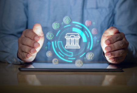 Digital banking protection with secure financial interface on tablet, showing money, savings and fintech icons with hands guarding the system.の写真素材