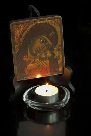 One icon with Mary and baby Jesus and one candle in front of the picture.の写真素材