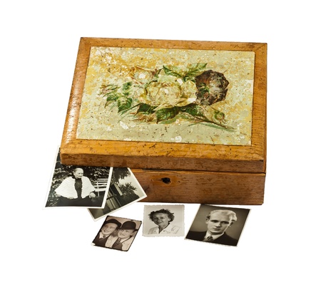 Old shabby chic wooden box with old photos, isolated