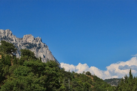 On a bright sunny day over Mount Ai-Petri clouds gatherの写真素材