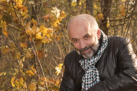 Portrait of middle-aged man with a beard in the autumn forestの写真素材
