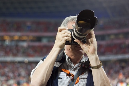 DONETSK, UKRAINE - JULY 10, 2011. Unidentified professional sports photographer during the first match of Championship of Ukraine 2011-2012 in Donbass Arena between Shakhtar Donetsk and Kiev Obolon.のeditorial素材