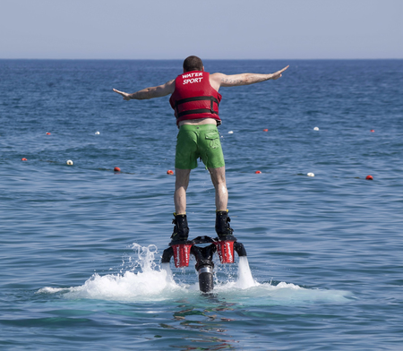 CAMYUVA, KEMER, TURKEY - JULY 16, 2015: Unidentified Turkish man studying extreme flyboard. Extreme water sports are increasingly popular on the beaches of Turkeyのeditorial素材