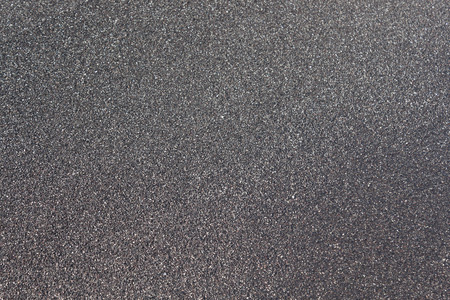 The famous black sand beaches of Santorini. Background, Texture