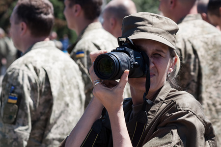 SLOVIANSK, UKRAINE - JULY 5, 2016: Unidentified woman photographs in Sloviansk  at the ceremonial meeting in honor of the second anniversary of Sloviansk liberation from Russian fightersのeditorial素材