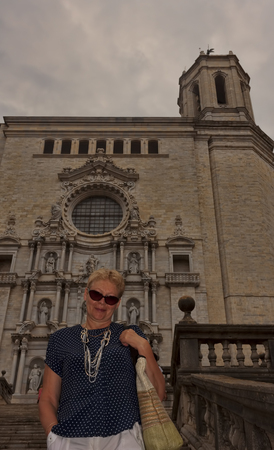 Middle-aged woman on the steps of the Girona Cathedralの写真素材