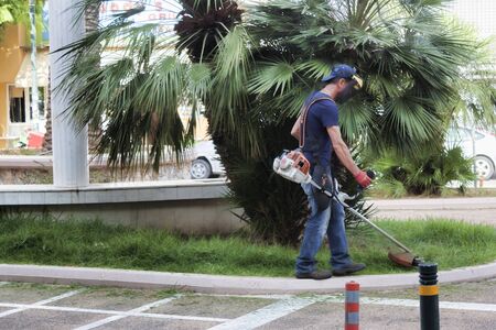 LOUTRAKI, GREECE - JULY 6, 2018: Unknown lawnmower on the street in Loutraki