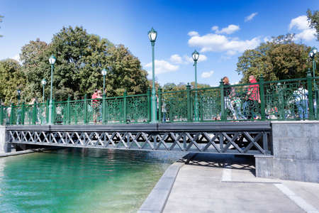 KHARKIV, UKRAINE - AUGUST 6, 2019: A bridge across the lake in the renovated Shevchenko Garden in Kharkov. There are always a lot of visitorsのeditorial素材