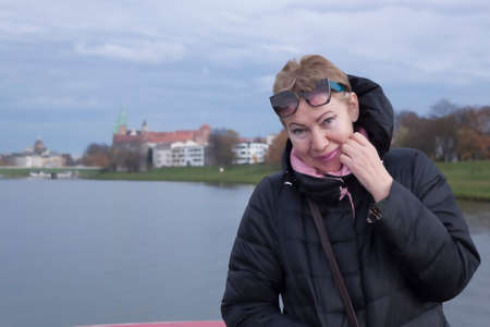 Portrait of a mature woman on the upper deck of a boat on the Vistula River in Krakow. The beginning...