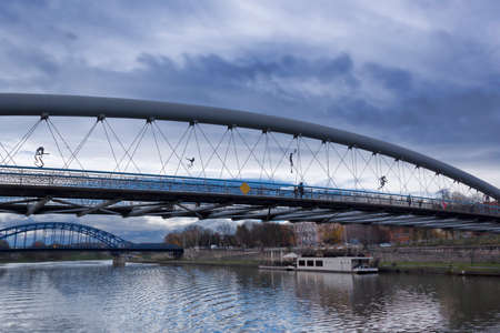 KRAKOW, POLAND - NOVEMBER 4, 2021: Bridges over the Vistula in Krakow - the pedestrian bridge of the...