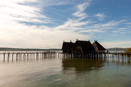 UNTERUHLDINGEN, GERMANY - APRIL 27, 2024: Stilt houses (Pfahlbauten), Stone and Bronze age dwellings in Unteruhldingen town, Lake Constance (Bodensee)のeditorial素材