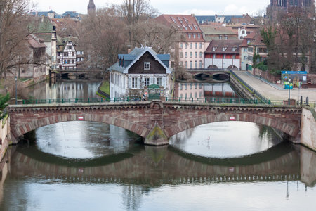 STRASBOURG, FRANCE - JANUARY 6, 2024: Bridges and old buildings on the embankment of the river Ileのeditorial素材
