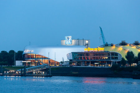 HAMBURG, GERMANY - AUGUST 15, 2024: Evening in the Hamburg harbor. On the opposite bank are theaters where the musicals The Snow Queen and The Lion King are being performedのeditorial素材