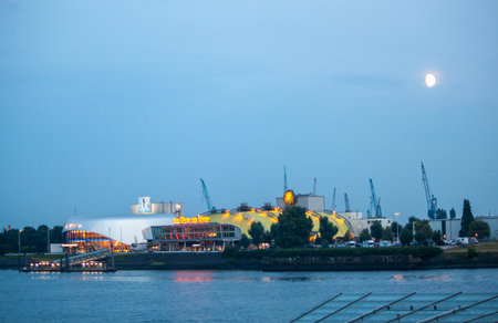 HAMBURG, GERMANY - AUGUST 15, 2024: Evening in the Hamburg harbor. On the opposite bank are theaters where the musicals The Snow Queen and The Lion King are being performedのeditorial素材