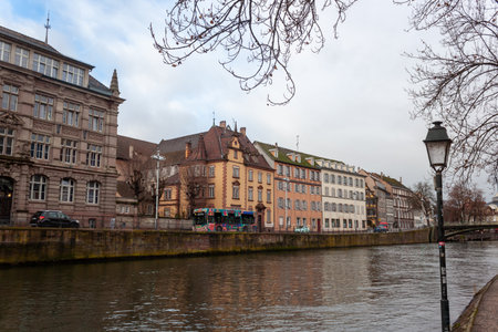 STRASBOURG, FRANCE - JANUARY 6, 2024: Old houses on the embankment of the Ill river in Strasbourg