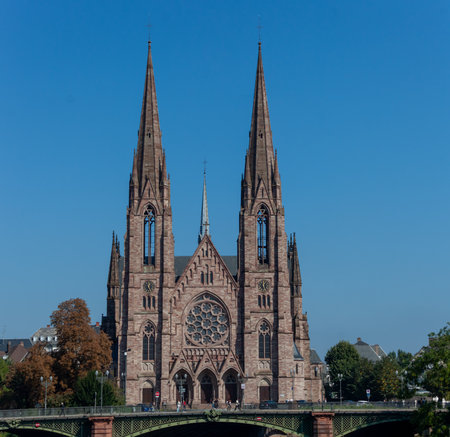 STRASBOURG, FRANCE - SEPTEMBER 21, 2024: View of St. Paul's Church of Strasbourg, Gothic Revival architecture building on blue sky background. Alsace, France. Tourist landmark, tourism destinationの写真素材