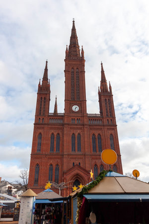 The photo captures the magnificent Marktkirche (Market Church) in Wiesbaden, Germany. This neo-Gothic red brick church with two tall spires dominates the Market Squareの写真素材