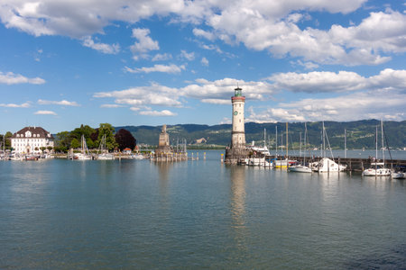 The harbor of Lindau at the Lake Constance with lighthouse and statue of Bavarian lion. Germanyの写真素材