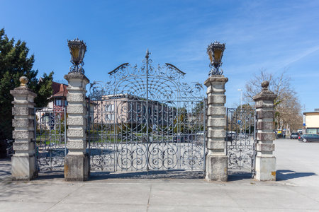 An ornate wrought-iron gate stands prominently on a clear, sunny day against a bright blue sky, likely marking a historical or formal entrance on the border between Konstanz, Germany, and Kreuzlingen, Switzerlandの写真素材