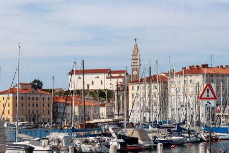 PIRAN, SLOVENIA - MAY 19, 2025: A charming view of the Piran marina and its historic skyline, captured on a bright day in Sloveniaの写真素材