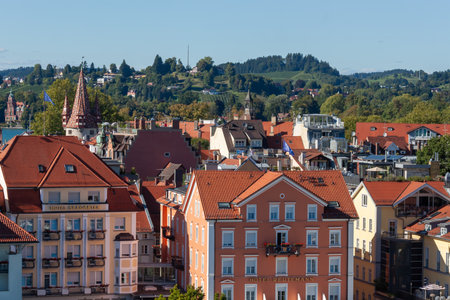 LINDAU, BAVARIA, GERMANY - AUGUST 31, 2025: Aerial view over the traditional red-tiled rooftops of...