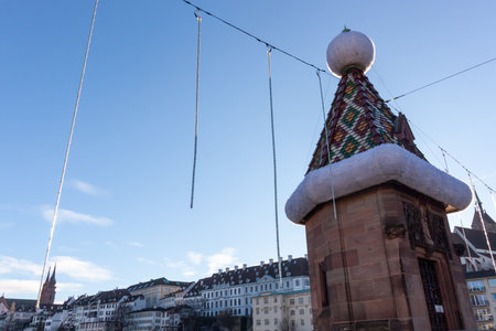 A decorative turret on a bridge over the Rhine River in Basel, Switzerland, adorned with a large...