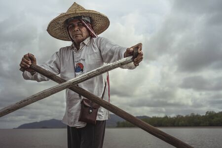 Krabi - October 21: Photography of a ferryman rowing the touring boat travel around mangrove forest at Tung Yee Peng, Lanta Island, Krabi Province of Thailand on October 21, 2018.のeditorial素材