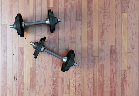 Dumbbell with black plates on a gym floor 3d Illustrationの写真素材
