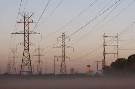 Overview of power line towers in the country morning mistの写真素材
