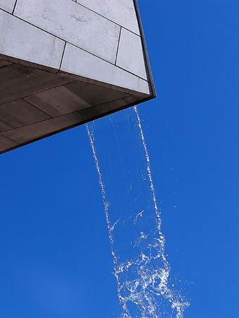 Water falls from a work of art (statue)の写真素材