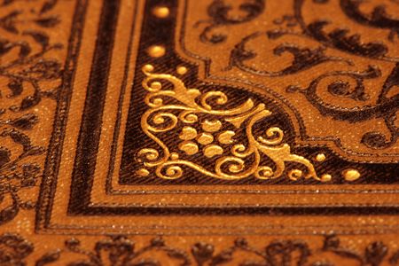 Antique bookcover (detail) with ornaments in brown and gold