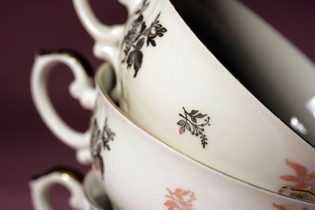 Antique decorated teacups with roses of gold