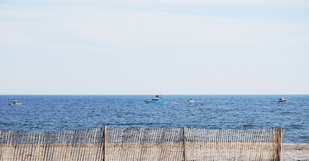 Beach sand dunes on hilly terrain with pretty fenceの写真素材