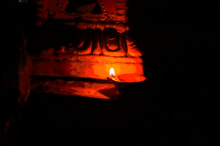 Burning candle in a Buddhist temple at night, close-upの写真素材