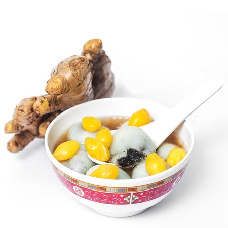 Black seasame seeds ball and ginkgo biloba in ginger teaの写真素材