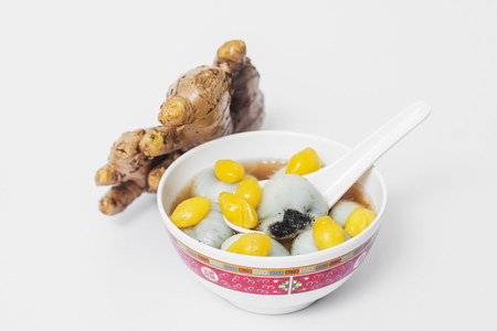 Black seasame seeds ball and ginkgo biloba in ginger teaの写真素材