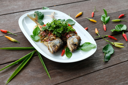 fried mackerel fish and chilli sauce on white plateの写真素材