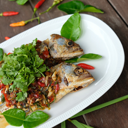 fried mackerel fish and chilli sauce on white plateの写真素材