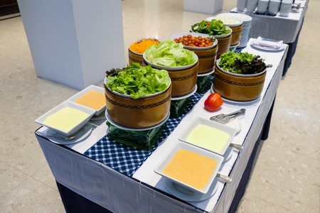 Salad bar and sauce on table for partyの写真素材