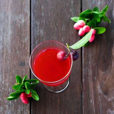 Karonda Fruit juice in glass on wood tableの写真素材